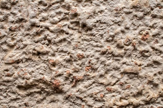 Old weathered plaster wall of village house closeup as background