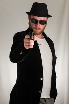 Black Dressed Young Man Holding a Pistol Gun