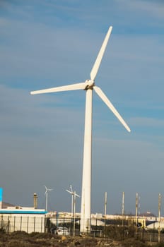 Eletric Power Generator Wind Turbine over a Cloudy Sky