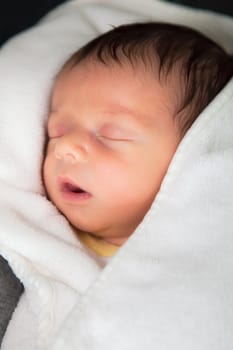 Newborn baby boy sleeping peaceful at home.