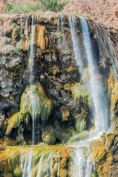 one woman bathing at ma'in hot springs waterfall in jordan middle east