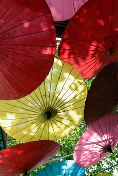 Traditionall umbrellas and faechers from Paier are produced in a paper screen factory in Chiang Mai in the north of Thailand in South East Asia.