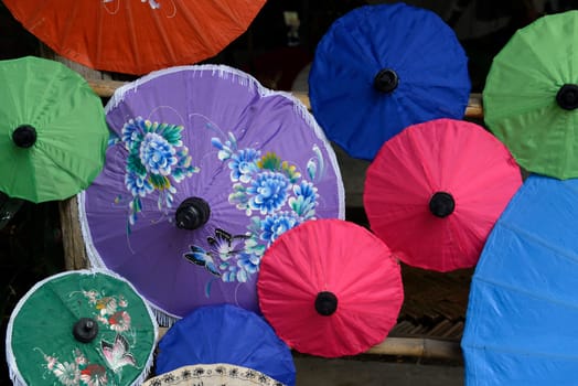 Traditionall umbrellas and faechers from Paier are produced in a paper screen factory in Chiang Mai in the north of Thailand in South East Asia.