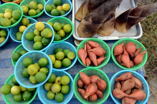 Exotic fruits and lemons at a regional market on the island of Phuket in the south of Thailand in South East Asia.