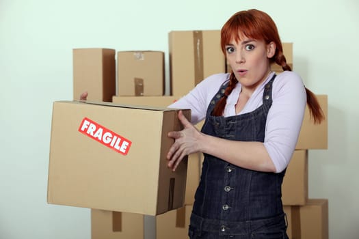 Woman carrying fragile box