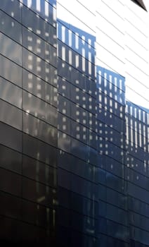 The photography of light reflections and shadow patterns on a striking sheet metal facade.