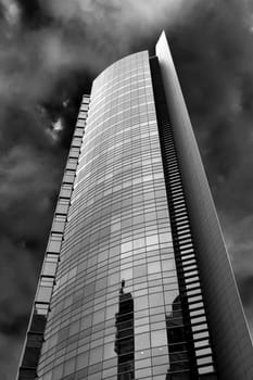 High-rise apartment building in black and white detail in the sky.