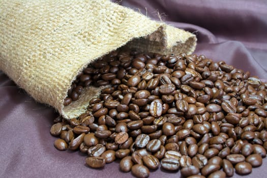 Detail of coffee beans and jute bag with background
