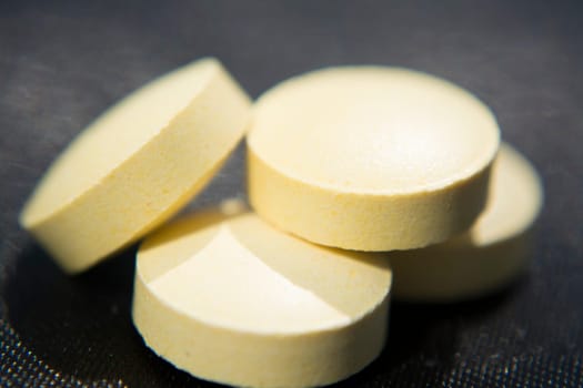 Macro to a round yellow pills