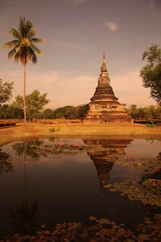 A chedi at the Wat Mahathat Temple in the temple complex of Alt-Sukhothai in Sukhothai province in northern Thailand in South East Asia.