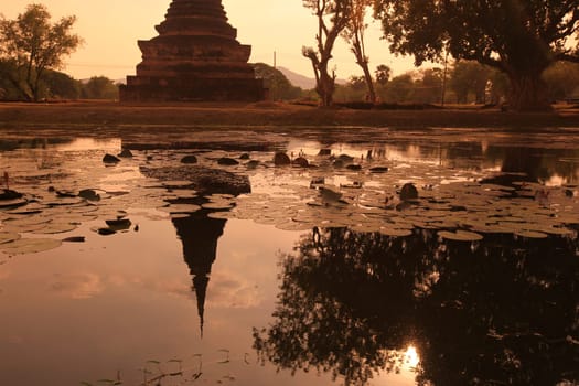 A chedi at the Wat Mahathat Temple in the temple complex of Alt-Sukhothai in Sukhothai province in northern Thailand in South East Asia.
