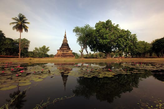 A chedi at the Wat Mahathat Temple in the temple complex of Alt-Sukhothai in Sukhothai province in northern Thailand in South East Asia.