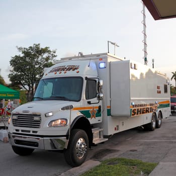 WILTON MANORS, FLORIDA - JUNE 22, 2013: Broward County Sheriff Mobile Command truck parked and ready with a very large antenna before the evening gay pride parade along Wilton Drive in Wilton Manors.