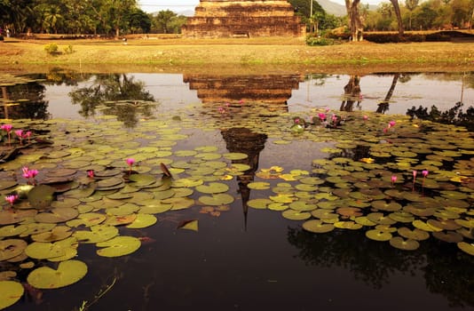 A chedi at the Wat Mahathat Temple in the temple complex of Alt-Sukhothai in Sukhothai province in northern Thailand in South East Asia.