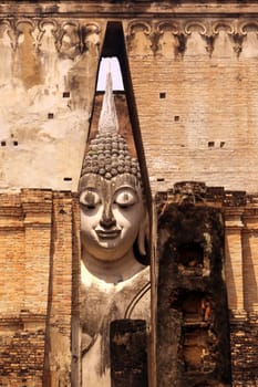 The Buddha figure in the Wat Si Chum temple in the temple complex of Alt-Sukhothai in the province of Sukhothai in northern Thailand in South East Asia.