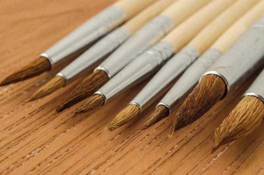 New Wooden Different Paintbrush Set Texture over a Colored Background