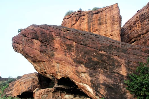 Giant rock leaning over smaller horizontal rocks at Badami, Karnataka, India, Asia