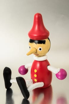 Pinocchio Toy Statue on a Colored Background