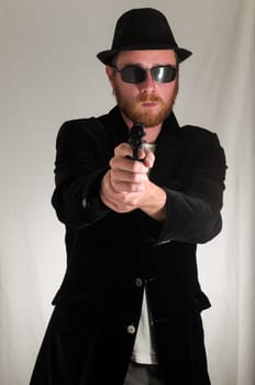 Black Dressed Young Man Holding a Pistol Gun