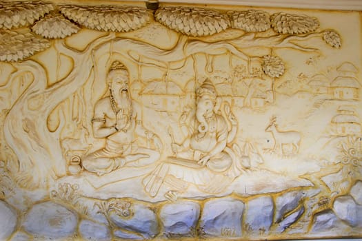 Wall panel at Shaktinagara Gopalakrishna Temple depicting Maharishi  Vyas dictating story of epic Mahabhatata to Ganesha, Mangalore, Karnataka, India, Asia