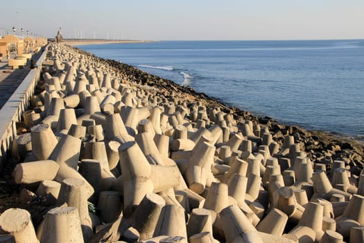 Dumping precast concrete blocks to prevent sea erosion at Port Beach, Dwaraka, Gujarath, India, Asia