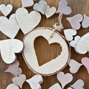 Wooden background with colorful hearts