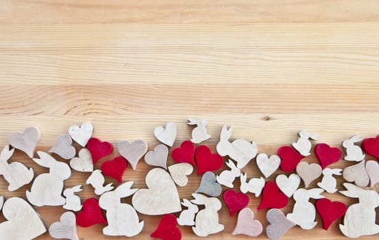 Background made of wood with hearts and Easter bunnies