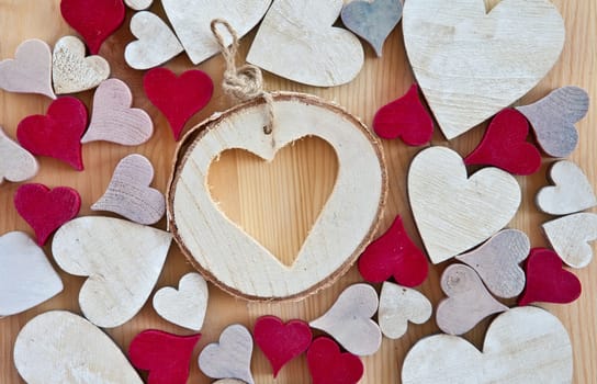 Wooden background with colorful hearts