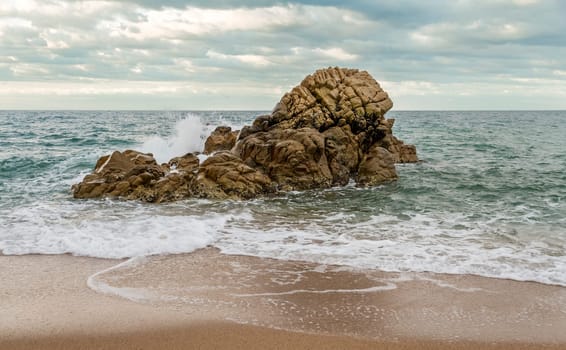 Wave breaking on a rock in the Mediterranean Sea, Costa Brava. Spain