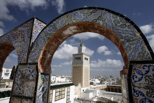 The Zaytouna Mosque or Grand Mosque in Souq or Bazzar in the Old Town of Tunis on the Mediterranean Sea in Tunisia in North Africa.