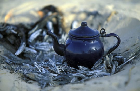 A Bedouin while cooking tea in Wuestensand in douz in the south of Tunisia in North Africa.