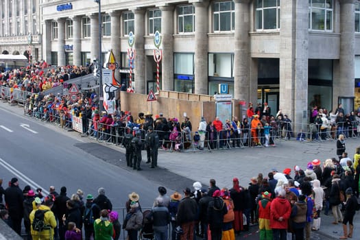 Cologne,Germany – March 02,2014: Colourfully dressed people wearing masks and costumes await the carnival procession on March 2,2014 in Cologne.