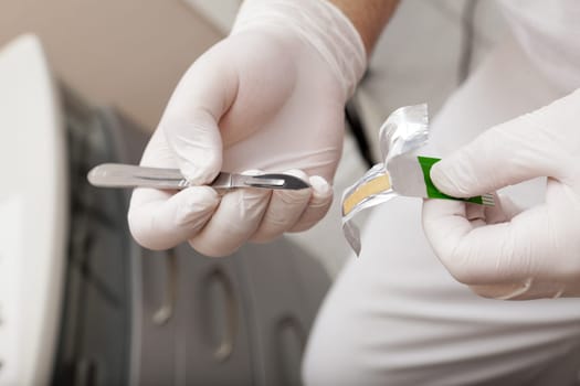Foot care worker with a scalplell in hand