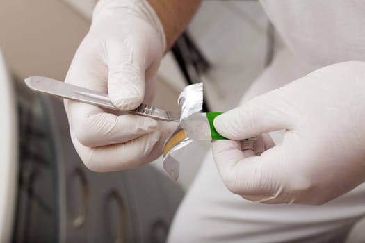 Foot care worker attaches blade to scalpel