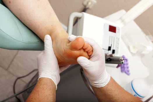 Foot care worker massages feet after treatment