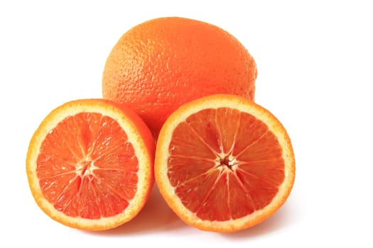 Blood orange (Citrus x sinensis),whole and halved fruit exposed against a white background