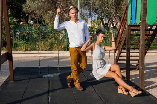 young elegant couple with fashionable clothes in summer leisure park outdoors
