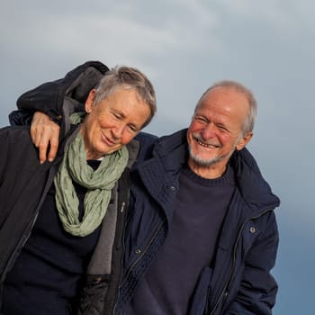 older seniors couple happy laughing in holiday leisure natural ostsee