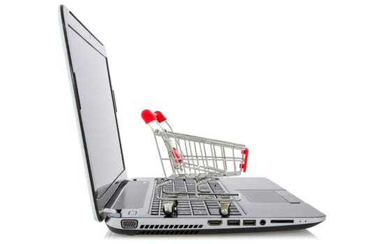 E-commerce. Shopping cart on laptop over a white background