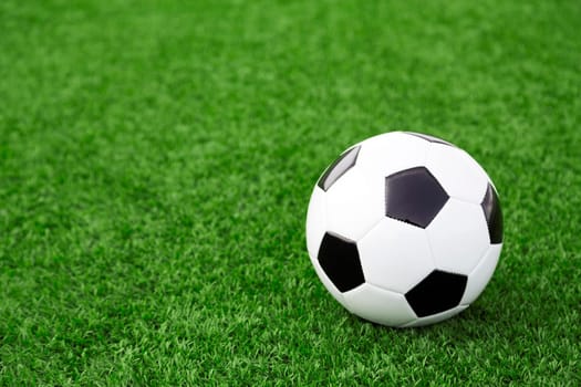 Traditional soccer ball on soccer field
