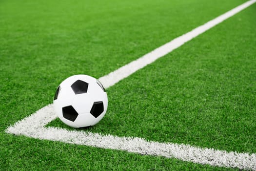 Traditional soccer ball on soccer field