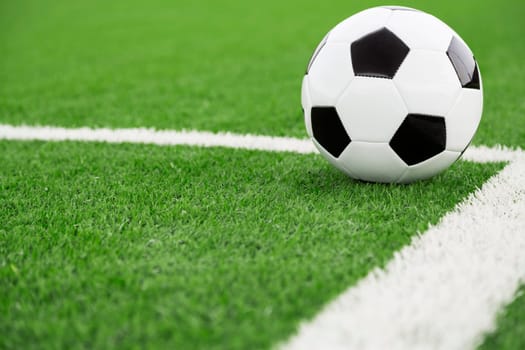 Traditional soccer ball on soccer field