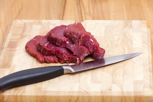 Four slices of beef fillet on cutting board