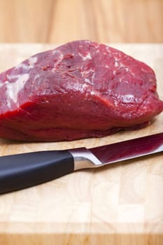 Close-up beef fillet with kitchen knife