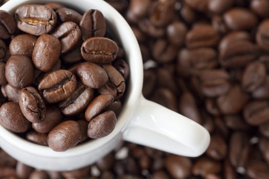 Close-up espresso cup with coffee beans