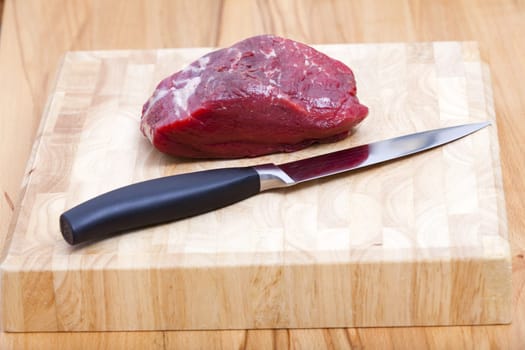 Whole piece of beef filt on a cutting board
