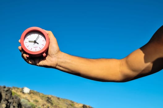 Time Concept White Sand Hourglass on the Volcanic Rocks
