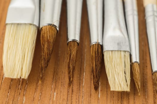 New Wooden Different Paintbrush Set Texture over a Colored Background