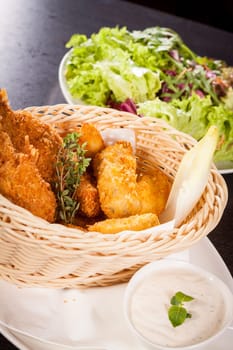 Crispy fried chicken wings with a dip on a plate