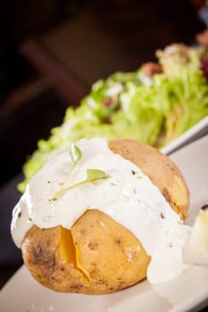 fresh foilpotato from the oven with herb quark sour cream and fresh herbs